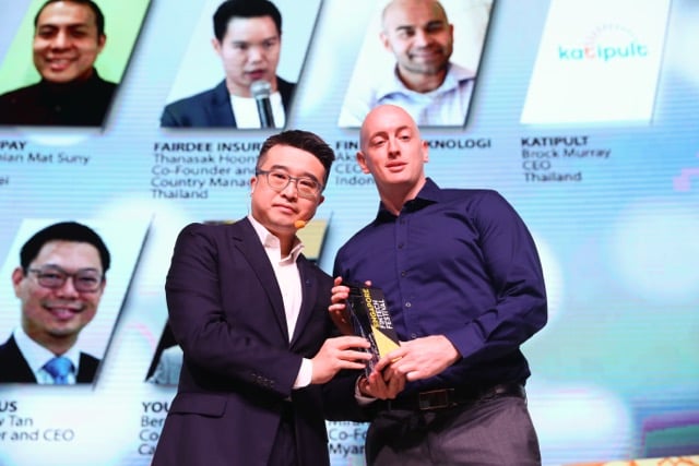 Katipult winning an award at Singapore Fintech Festival - CEO Brock Murray receiving the prize close up